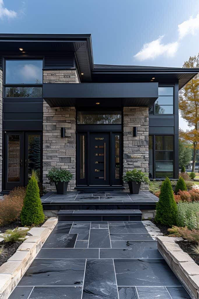 Sleek black front door with modern sidelights and matte black hardware, surrounded by minimalist landscaping